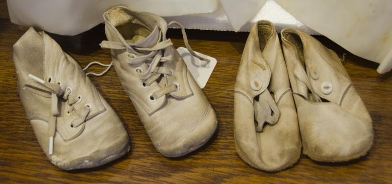 In addition to wedding clothes, the exhibit features baby shoes from the 1940s and children's clothes. BY GEORGIA SPARLING